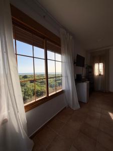 a room with a large window with a view at Vista al faro in Cádiz
