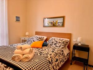 a bedroom with a bed with towels on it at Respiro Mediterraneo in Mondello