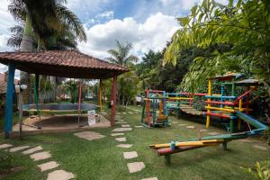 a park with a playground with a slide and a play structure at Hotel Alpha Ville Chalés in Conceição da Ibitipoca