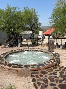 a small pool of water in a stone circle at Restaurante y Cabañas Cané in Colón