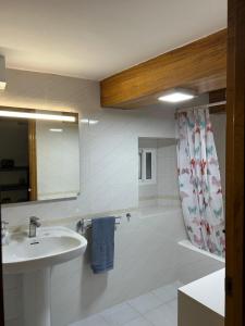 a bathroom with a sink and a shower at Casa Conchas in Ferreira +21 photos