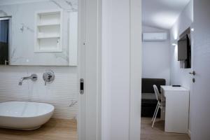 a bathroom with a white tub and a sink at dellarocca4 in Cefalù +22 photos