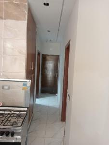 a hallway of a kitchen with a stove and a door at Hurghada, El-Marina in Hurghada