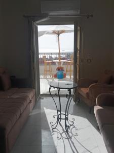 a living room with a table and a patio with an umbrella at Hurghada, El-Marina in Hurghada