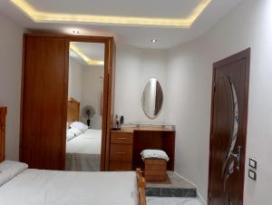 a bedroom with two beds and a mirror at Hurghada, El-Marina in Hurghada +6 photos