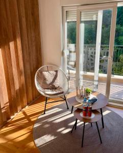 a living room with a chair and a table at Moon apartment in Mostar