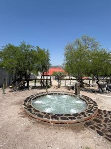 a small pool of water in a field with trees at Restaurante y Cabañas Cané in Colón