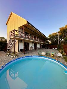 a house with a large swimming pool in front of it at Апарт-готель HAPPY in Fontanka