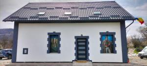 a small house with two windows and a roof at Piscina Margaia in Lupşa