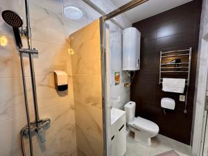 a bathroom with a shower stall and a toilet at Апарт-готель HAPPY in Fontanka +71 photos