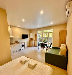 a living room with a bed and a kitchen at Апарт-готель HAPPY in Fontanka