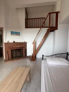 a living room with a staircase and a fireplace at Filonoe apartment in Gialiskari