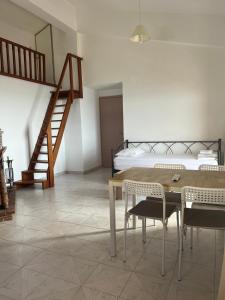 a bedroom with a bed and a table and chairs at Filonoe apartment in Gialiskari