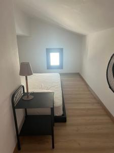 a bedroom with a bed and a table with a lamp at Filonoe apartment in Gialiskari +4 photos