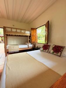 a bedroom with two bunk beds and a window at Finca Hostal Ágora in Jardin