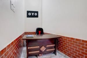 an office with a desk and a brick wall at SPOT ON Hotel MS Grand in Lucknow