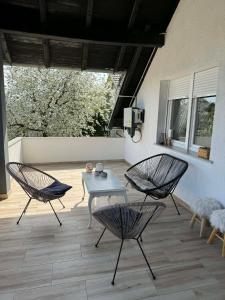 two chairs and a table on a patio at U prolazu in Đakovo
