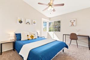 a bedroom with a blue bed and a ceiling fan at The AZ Escape in Tucson +43 photos