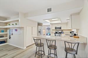 a kitchen with three bar stools and a counter at The AZ Escape in Tucson
