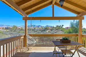 a wooden porch with a table and a swing at The AZ Escape in Tucson