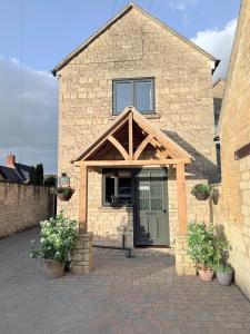 a house with an awning over the front door at Misty View - 2 Bed Cottage in Winchcombe in Winchcombe