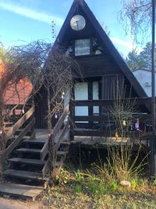 a house with a staircase leading to the front door at Joyosada - Ferienhäuser in Seenlandschaft in Prusim