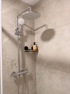 a shower with a yellow container on a shelf at Horizonte da Vinha in Santo Tirso +32 photos