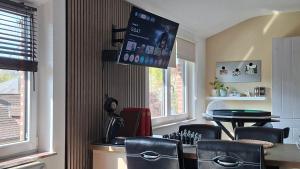 a dining room with a table and chairs and a tv at "En Aqualye" Appartement 2 personnes chez l'habitant in Aywaille +21 photos