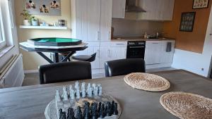 a kitchen with a table with a ping pong ball at "En Aqualye" Appartement 2 personnes chez l'habitant in Aywaille