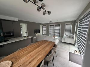 a kitchen and dining room with a wooden table and chairs at Burgvliet41 in Oostkapelle