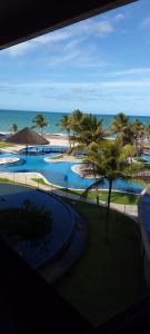 a view of a resort with palm trees and the ocean at Hotel Pirâmides natal in Natal