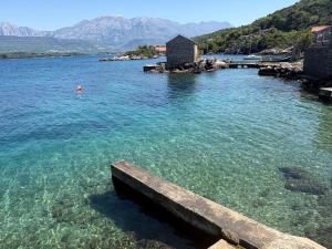a view of a body of water with a pier at BlueWave Apartments in Tivat +25 photos