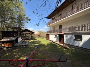 a yard with a playground and a building at Apartmány Veselka in Oslnovice +4 photos