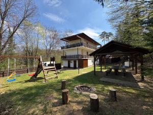 a playground in front of a house with a building at Apartmány Veselka in Oslnovice