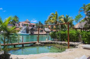 a resort with a water park with a swing at Chez Waffle Hotel in Puerto Aventuras