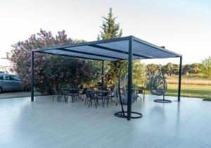 a patio with tables and chairs under a canopy at Vila Kollari in Ulcinj