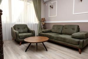 a living room with a couch and two chairs and a table at ZARO Apartments in Bitola