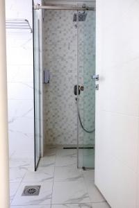 a shower with a glass door in a bathroom at ZARO Apartments in Bitola