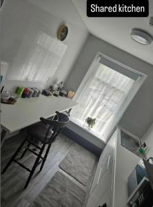 a small kitchen with a table and a window at The Queens Hotel in Rhondda