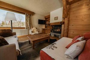a living room with a teddy bear sitting on a table at appartement 103m2 près de Megève, face à télécabine la Princesse,2 chambres , garage, local à ski in Demi-Quartier