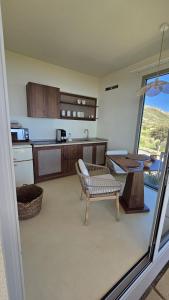 a kitchen with a bench and a table in a room at Tendu' Punta Bianca Glamping Camp in Palma di Montechiaro