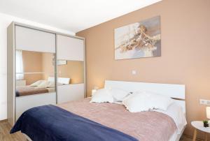 a bedroom with a large bed and a mirror at Villa Fila in Sinj +27 photos