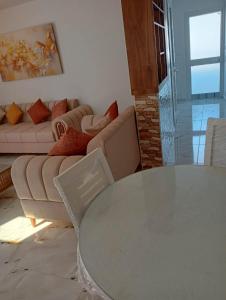 a living room with a table and a couch at Appartement chic et luxueux in Rejiche