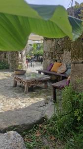 a group of picnic tables in a stone wall at Ecoresort Portobali in Jugueiros