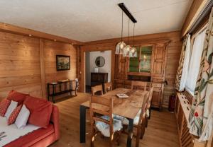 a dining room with a table and a couch at appartement 103m2 près de Megève, face à télécabine la Princesse,2 chambres , garage, local à ski in Demi-Quartier