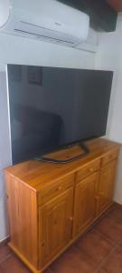 a wooden cabinet with a television on top of it at PUNTA SOL in Isla del Moral