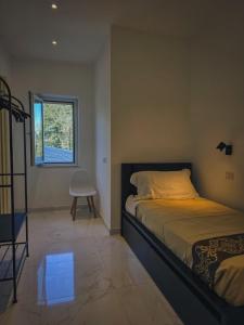a bedroom with a bed and a window and a chair at Casa Zora - Vista Mare in Vieste +44 photos