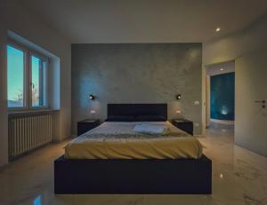 a bedroom with a large bed and a large window at Casa Zora - Vista Mare in Vieste