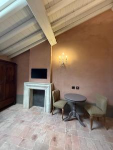 a room with a table and chairs and a fireplace at Casa Tarabuso B&B in Reggio Emilia