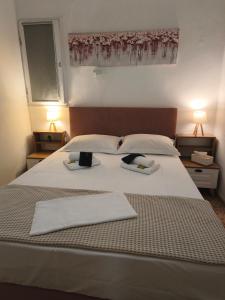 a bedroom with a large bed with two towels on it at SeaShell apartment Sea View, Castle View 200metres from the Beach in Sitia